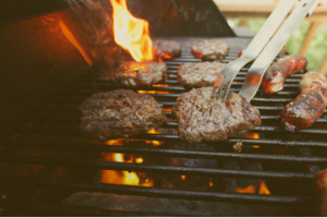 Burger patties and hotdogs on a grill
